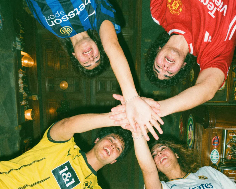Group of friends in football jerseys forming a team huddle during a pub golf night