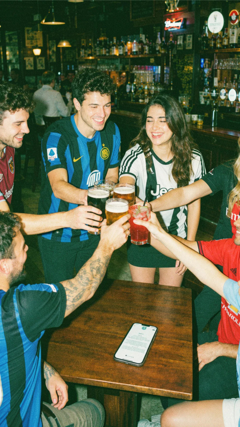 Group of friends cheering during a pub golf night out