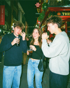 Friends relaxing with drinks in a pub during a pub golf game