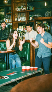 Friends playing a fun bar game together during a pub golf social