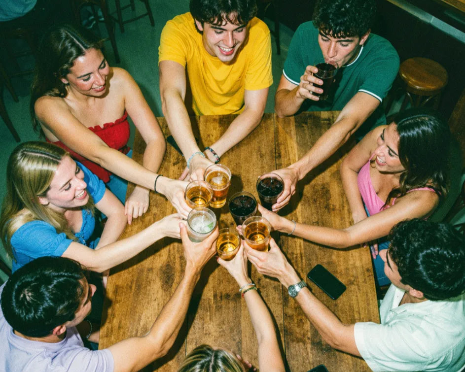 Friends cheering with their drinks while playing pub golf