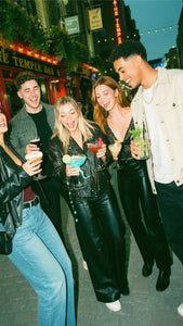 Friends on a pub crawl moving between bars during a pub golf game