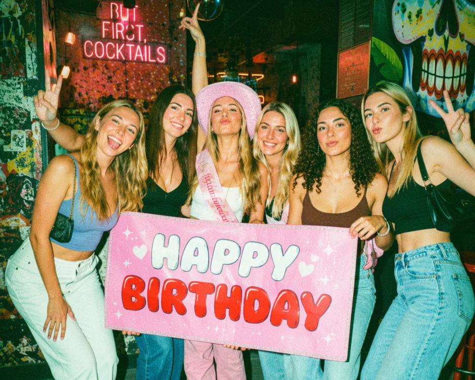 Friends celebrating a birthday together at a pub during a pub golf night
