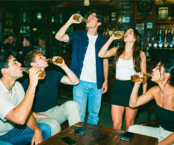 Friends cheering on a teammate during a fun pub golf challenge