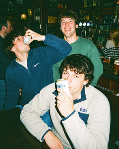 Friends taking on a light-hearted pub golf challenge at the bar