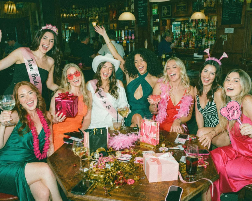 Group of friends celebrating a birthday on a pub golf night out