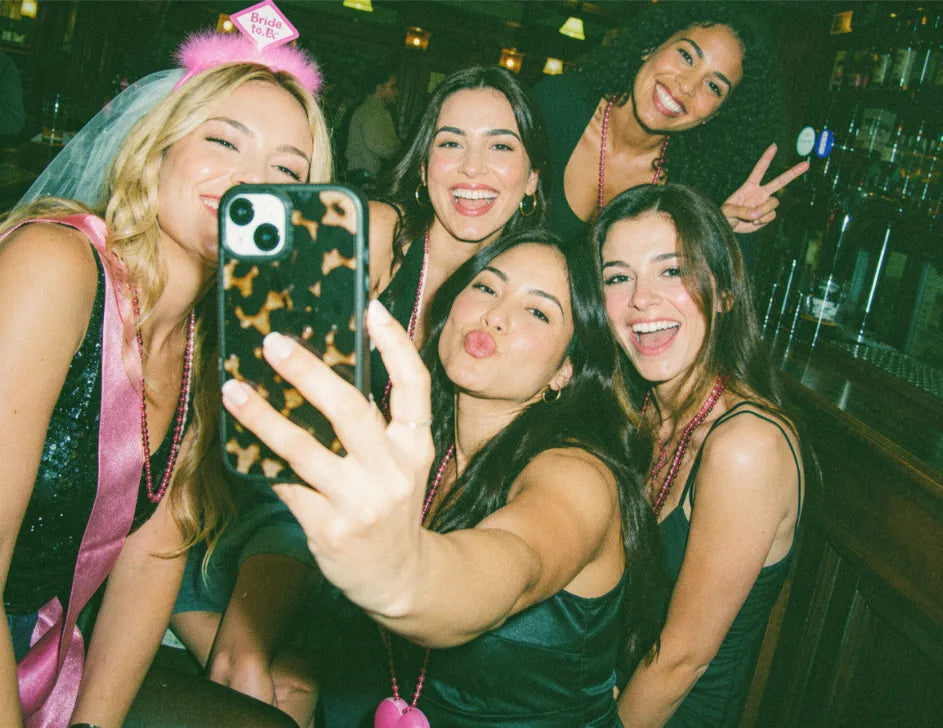 Friends on a hen do playing pub golf together on a night out