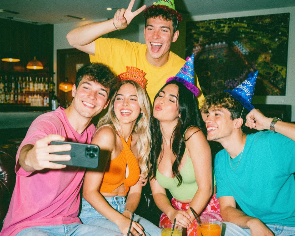 Group of friends enjoying drinks around a table on a pub golf night out