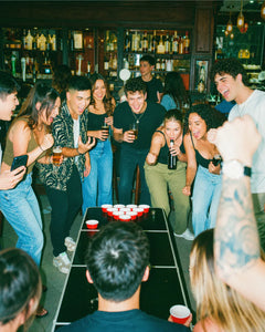 Friends taking on a fun pub golf challenge together at a bar table
