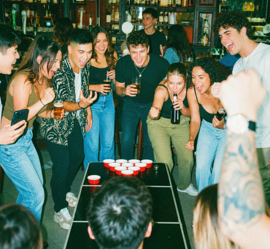 Friends taking on a fun pub golf challenge together at a bar table