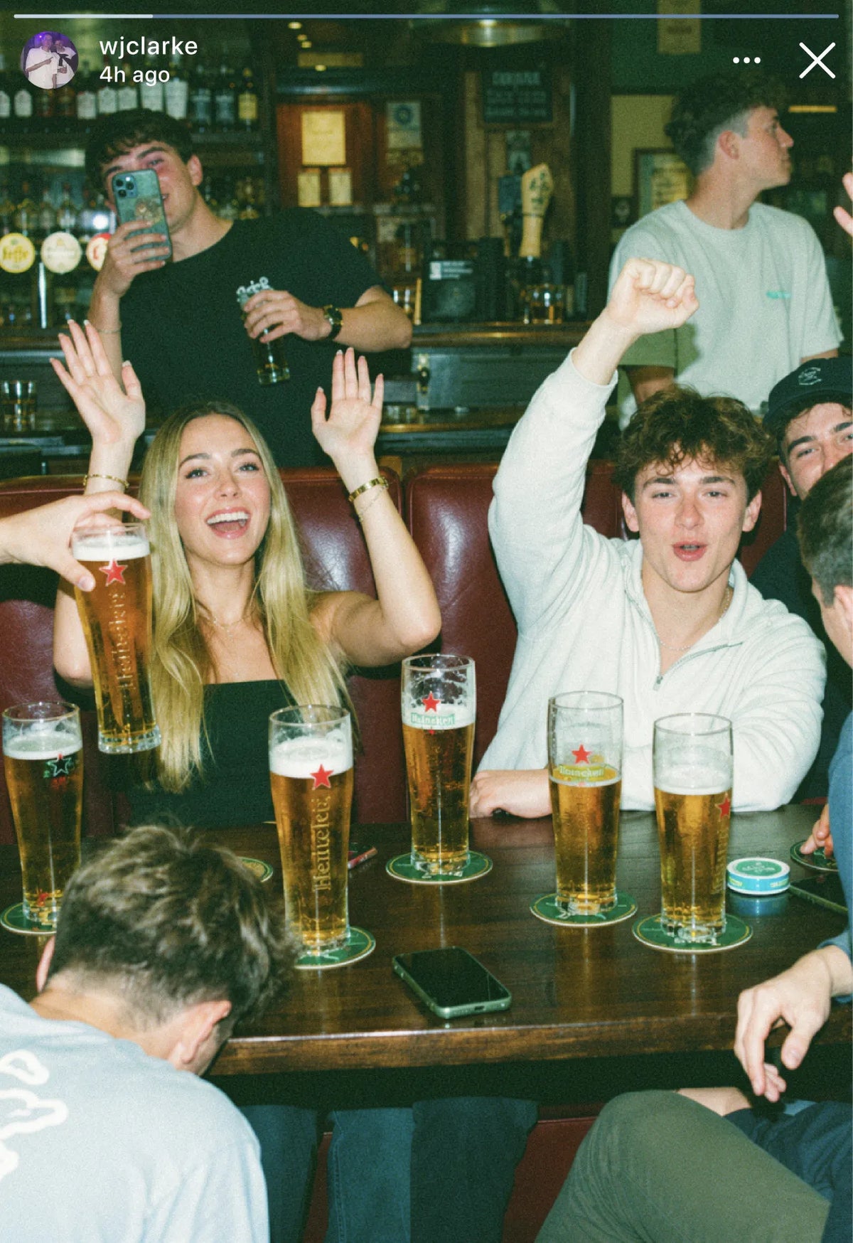 Instagram story of a group cheering with pints around a pub table on a pub golf round